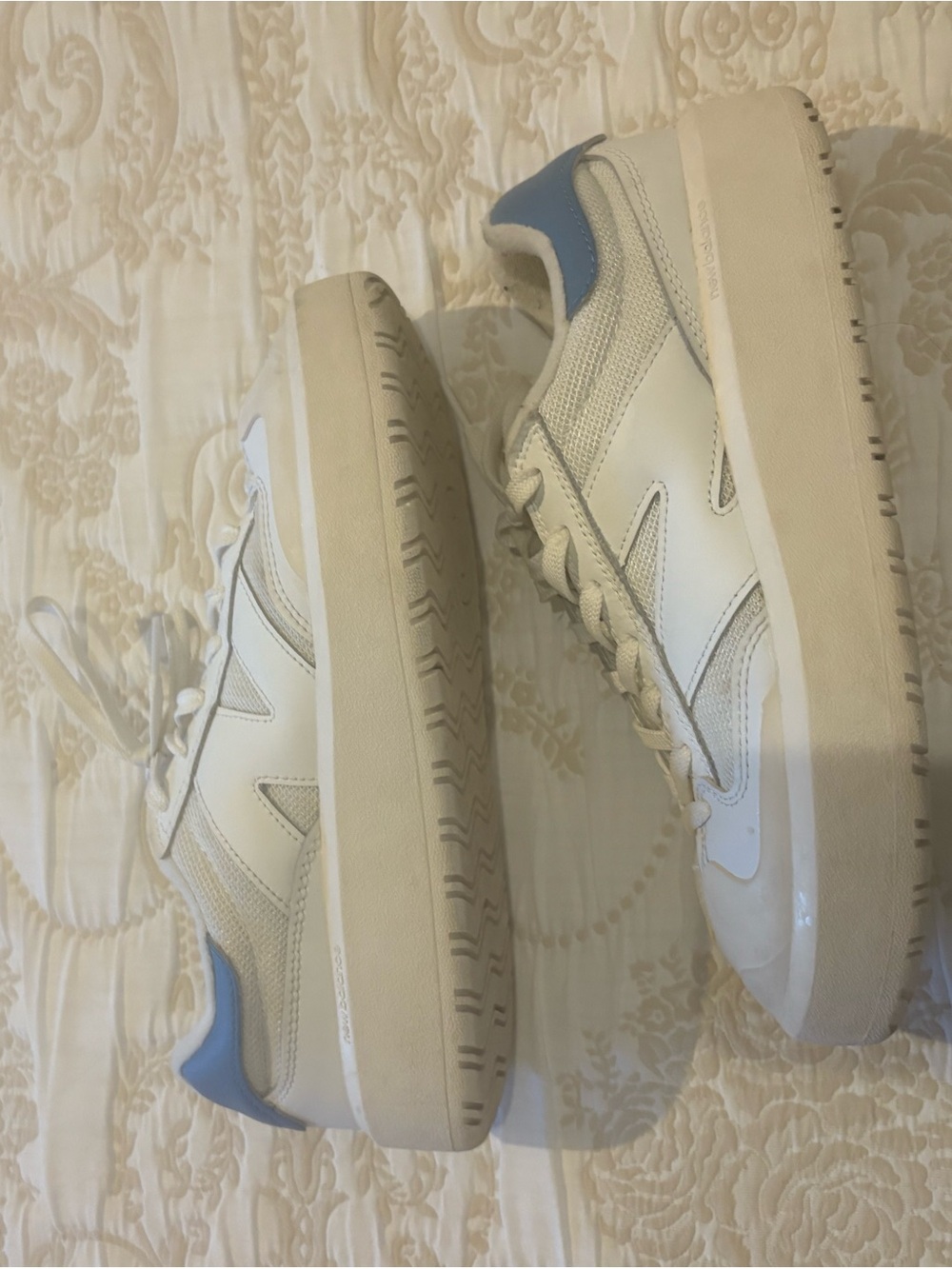 New Balance White Sneakers with Blue Heel Accent and Cream Tongue